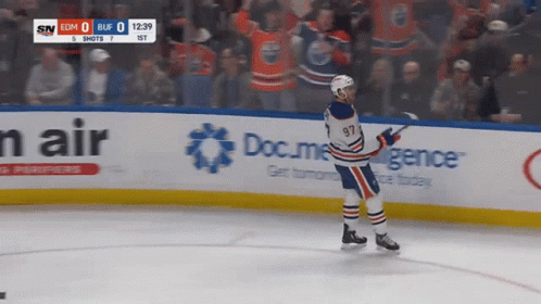A Hockey Player With The Number 97 On His Jersey Is Standing On The Ice GIF
