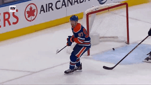 A Hockey Player With The Number 97 On His Jersey Stands On The Ice GIF