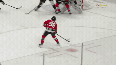 A Hockey Player With The Number 98 On His Back GIF