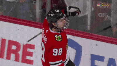 A Hockey Player With The Number 98 On His Jersey Stands On The Ice GIF