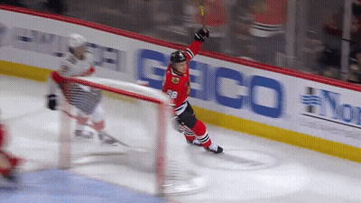 A Hockey Player With The Number 98 On His Jersey Stands On The Ice GIF