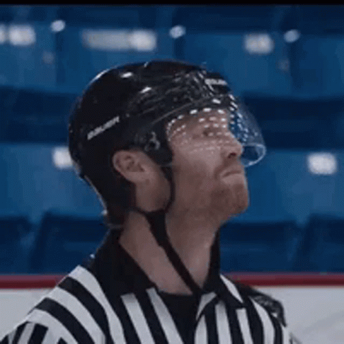 A Hockey Referee Wearing A Bauer Helmet And Visor GIF