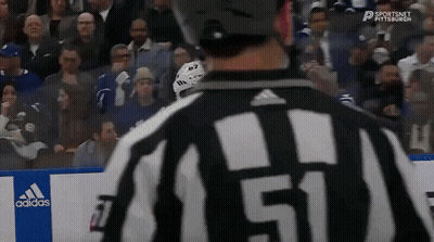 A Hockey Referee With The Number 51 On His Shirt GIF