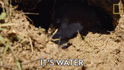 A Hole In The Ground With The Words " It 'S Water " Above It GIF