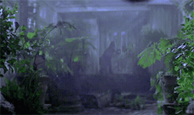 A Hook Is Hanging From A Ceiling In The Dark GIF