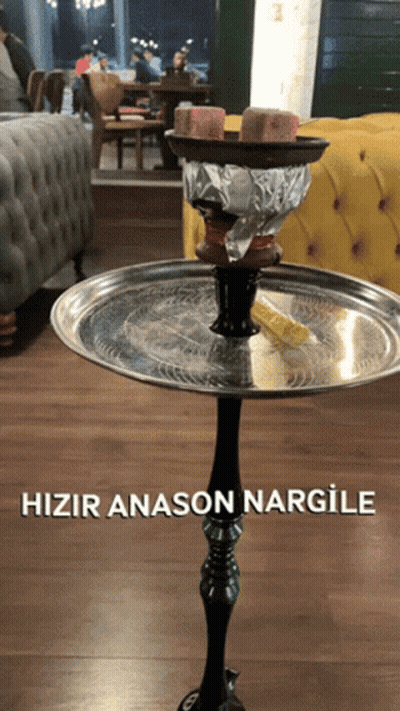 A Hookah Sitting On Top Of A Metal Tray That Says Hizir Anason Nargile On It GIF