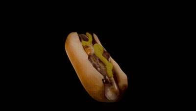 A Hot Dog On A Bun With Mustard And Pickles GIF