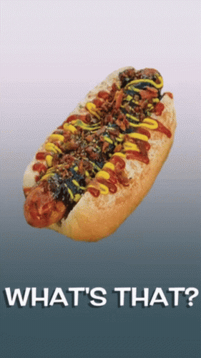 A Hot Dog With Ketchup Mustard And Bacon On A Bun With The Words What 'S That Written Below It GIF