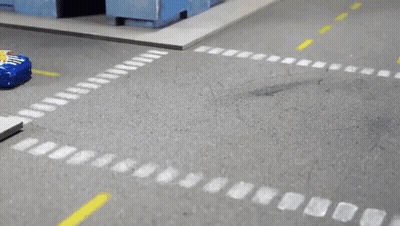 A Hot Wheels Car Is Driving Down A Street GIF