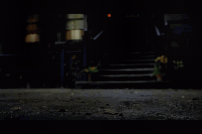 A House With Stairs And A Fence At Night GIF
