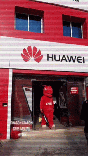 A Huawei Store Has A Red Dragon Mascot In Front Of It GIF