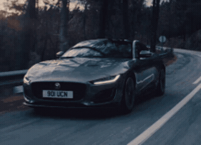 A Jaguar Is Driving Down A Road With A License Plate That Says 901 Ucn GIF