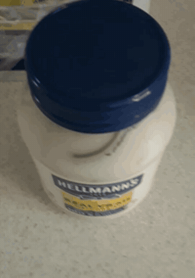 A Jar Of Hellmann 'S Mayonnaise Sits On A Table GIF