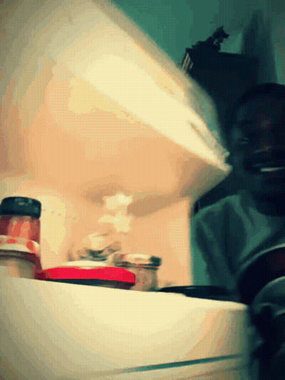 A Jar Of Tomato Sauce Sits On A Shelf In A Kitchen GIF