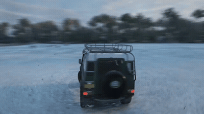 A Jeep Is Driving Through A Snowy Field With A License Plate That Says ' A ' On It GIF