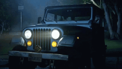 A Jeep Is Parked In Front Of A Sign That Says No Parking GIF
