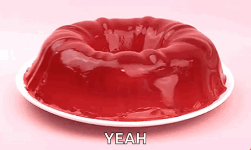 A Jelly Cake On A White Plate With The Word Yeah Written On It GIF