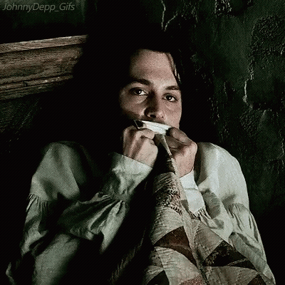 A Johnny Depp Gif Shows A Man Covering His Mouth With A Piece Of Cloth GIF