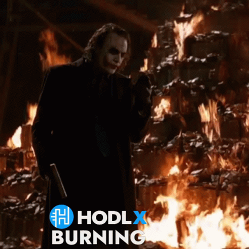 A Joker Standing In Front Of A Fire With The Words Hodlx Burning Above Him GIF