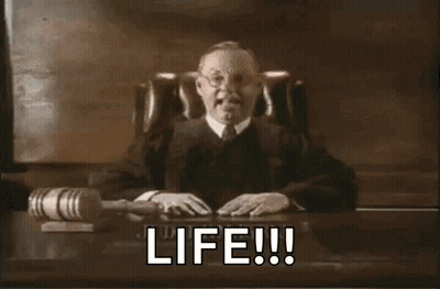 A Judge Is Sitting At A Desk With A Gavel And The Words Life Written On It GIF