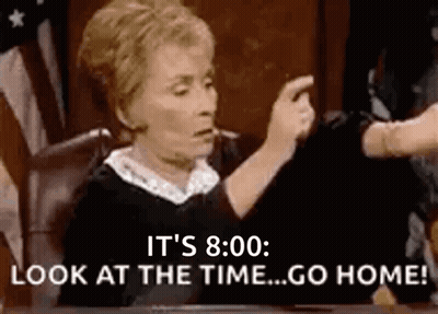 A Judge Is Sitting At A Table In A Courtroom Pointing At Someone . GIF