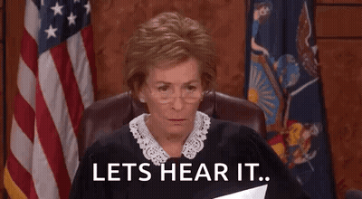 A Judge Is Sitting In A Courtroom Holding A Piece Of Paper And Says `` Lets Hear It '' . GIF
