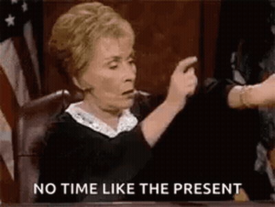 A Judge Is Sitting In A Courtroom Pointing At A Person . GIF