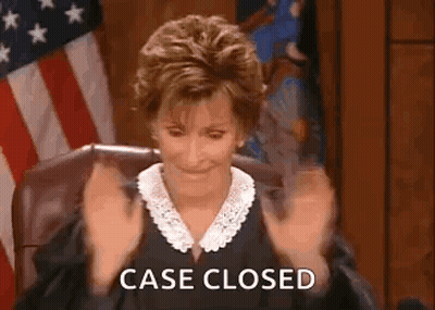 A Judge Is Sitting In A Courtroom With Her Hands In The Air And The Words `` Case Closed '' Written On The Screen . GIF