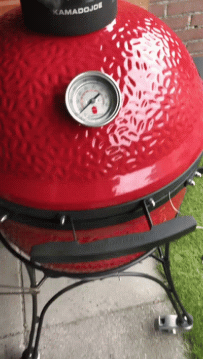 A Kamado Joe Grill With A Thermometer On Top GIF