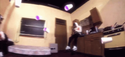 A Kitchen With A Purple Cup In The Air GIF
