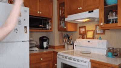A Kitchen With A Refrigerator That Has A Sticker That Says ' I Love You ' GIF