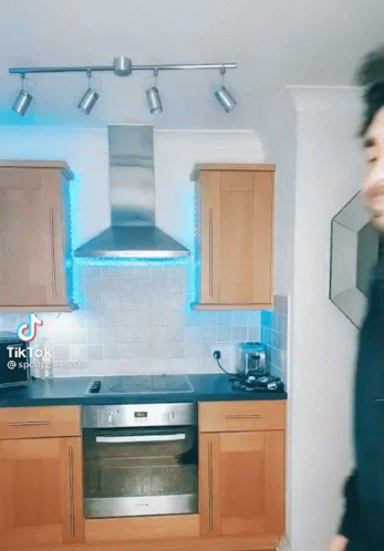 A Kitchen With A Stove Top Oven And A Hood That Says ' Tik Tok ' On It GIF