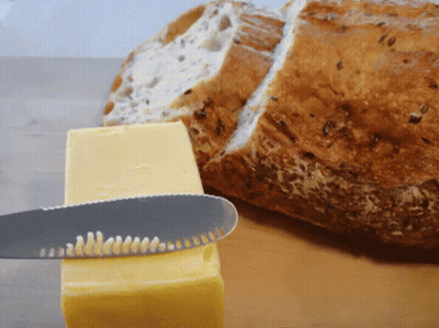 A Knife Is Cutting A Piece Of Butter Next To A Slice Of Bread GIF