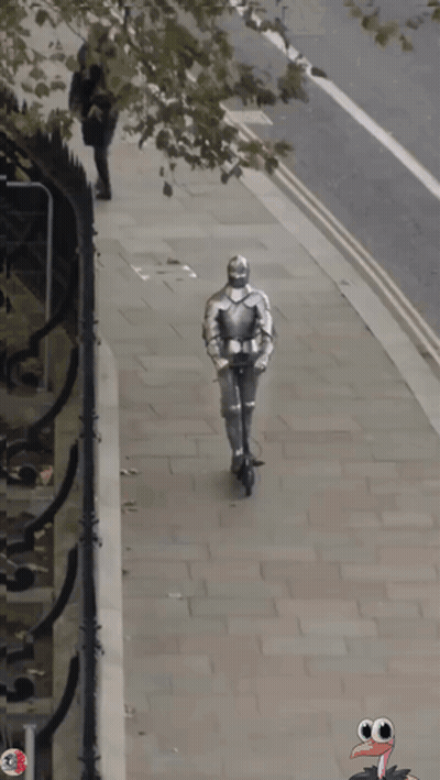 A Knight In Armor Is Walking Down The Street With A Turkey In The Background GIF
