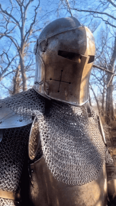 A Knight Wearing Chain Mail And A Helmet With A Cross On His Face GIF