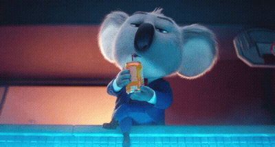 A Koala Bear In A Suit Drinking From A Can With A Straw GIF