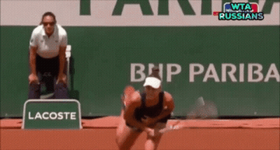 A Lacoste Sign Is In Front Of A Bnp Pariba Sign GIF