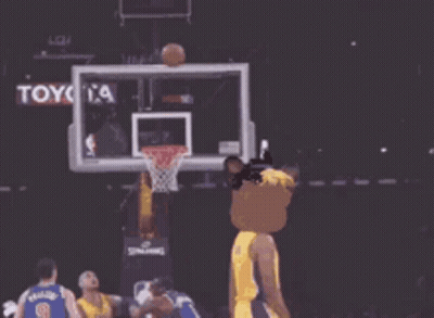 A Lakers Basketball Player Wearing A Mask Throws A Basketball Through A Hoop GIF