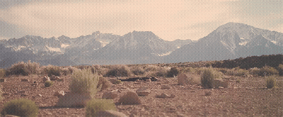 A Landscape With Mountains In The Background And Rocks In The Foreground GIF