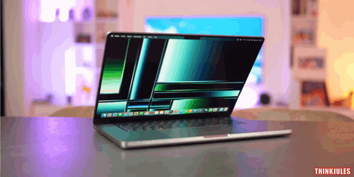 A Laptop Is Open On A Table And The Words Thinkjules Are On The Bottom Right GIF