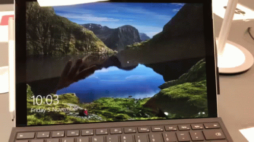 A Laptop Screen Shows The Time As 10:03 On Friday November 5 GIF