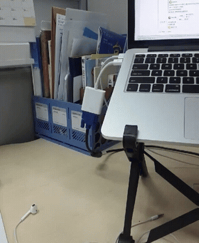 A Laptop Sits On A Desk Next To A Binder That Has A Sticker On It That Says ' A ' On It GIF