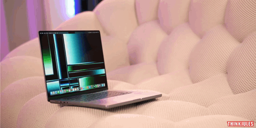 A Laptop Sits On A White Couch With Thinkjules Written On The Bottom Right Corner GIF