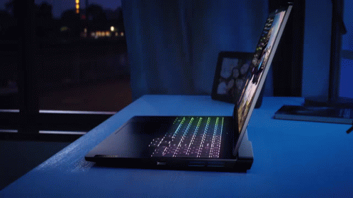 A Laptop With A Picture Of A Man And A Space Ship On The Screen GIF