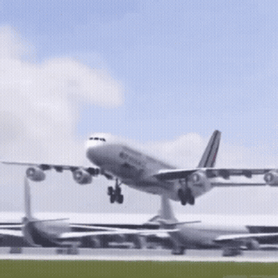 A Large Airplane Is Taking Off From A Runway GIF