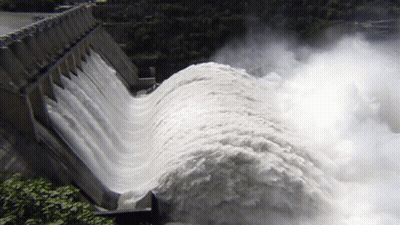 A Large Amount Of Water Is Coming Out Of A Large Dam GIF