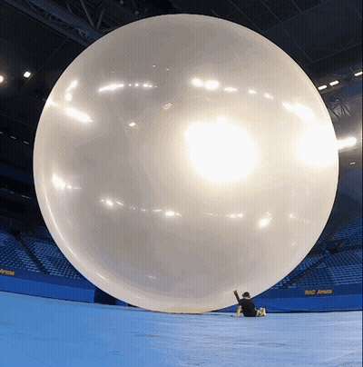 A Large Balloon In A Stadium With A Sign That Says Rio Arena On It GIF
