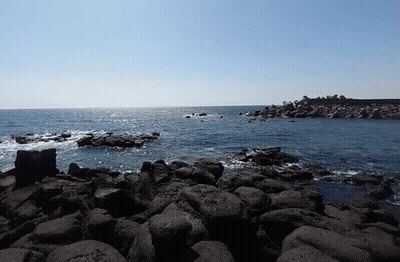 A Large Body Of Water Is Surrounded By Rocks GIF