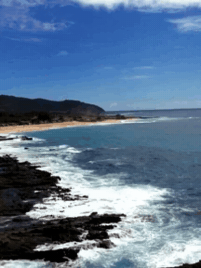 A Large Body Of Water Surrounded By Rocks And Mountains GIF
