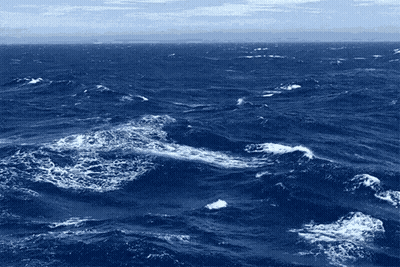 A Large Body Of Water With Waves And Foam Coming Out Of It GIF